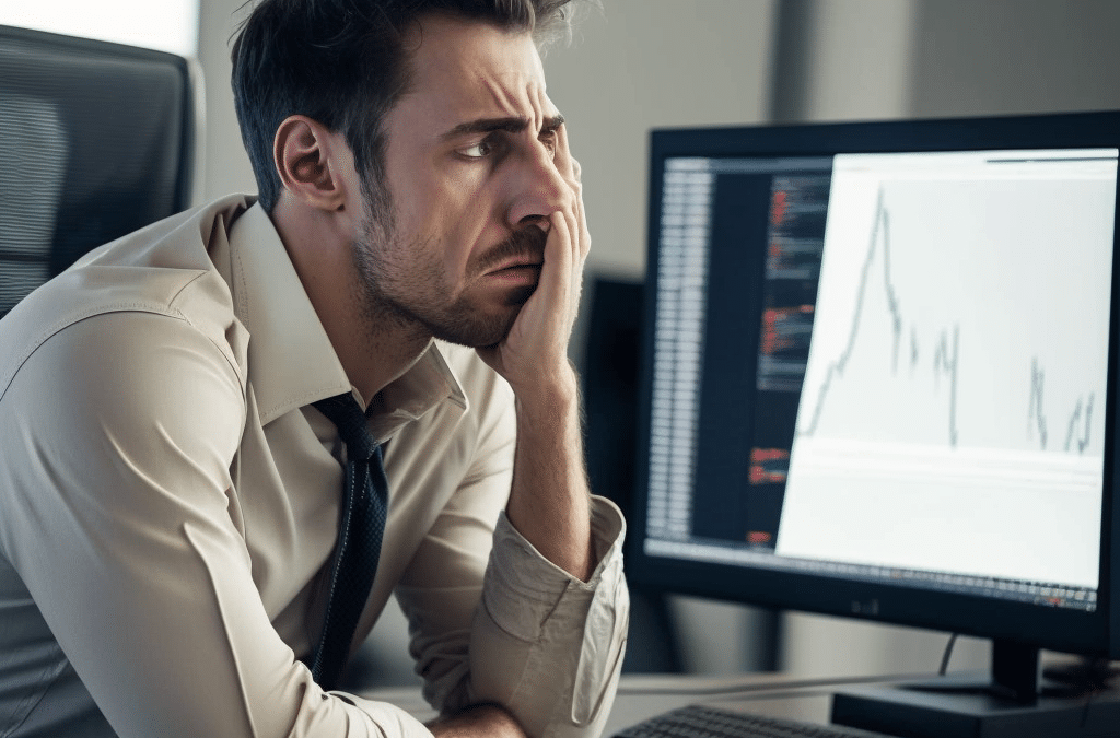day trading sitting in front of a computer looking stressed